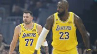 Los Angeles Lakers guard Luka Doncic (77) and forward LeBron James (23) stand on the court in the first quarter against the Cleveland Cavaliers at Rocket Arena.