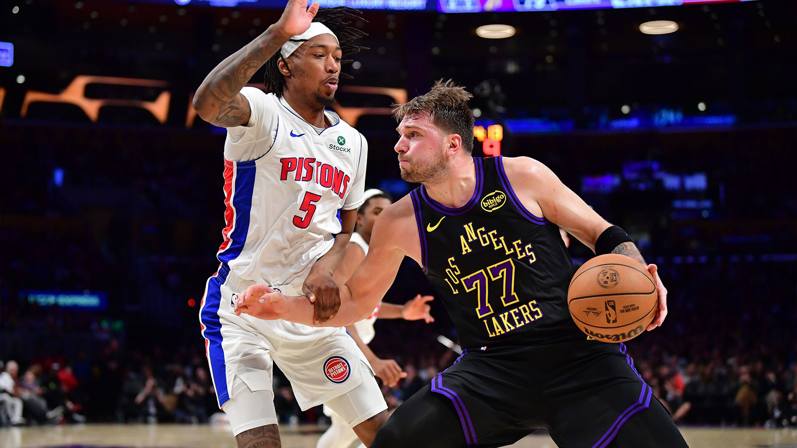 Los Angeles Lakers guard Luka Doncic (77) moves the ball against Detroit Pistons forward Ronald Holland II (5) during the second half at Crypto.com Arena. 