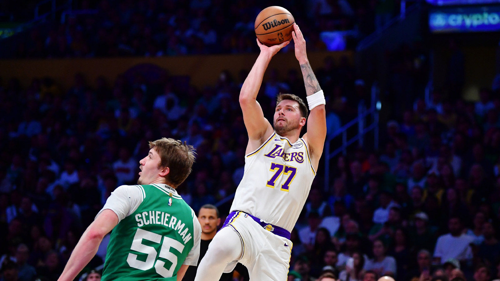 Los Angeles Lakers guard Luka Doncic (77) shoots against Boston Celtics guard Baylor Scheierman (55) during the second half at Crypto.com Arena.