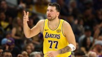Los Angeles Lakers guard Luka Doncic (77) celebrates a three point shot against the Phoenix Suns in the first half at Mortgage Matchup Center.