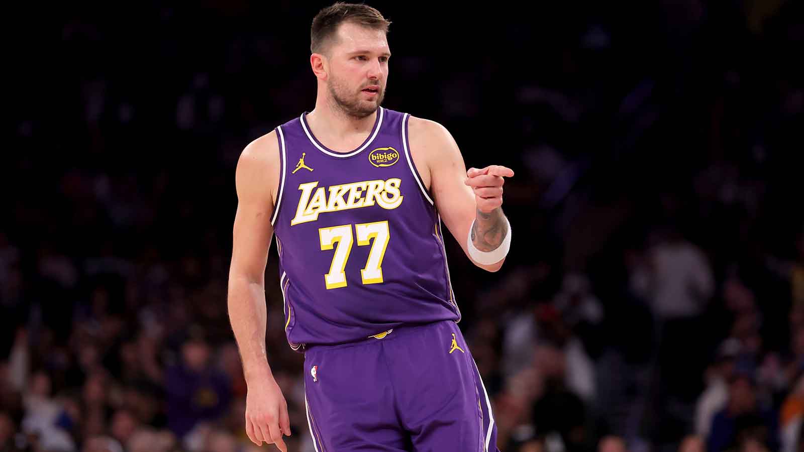 Los Angeles Lakers guard Luka Doncic (77) points in the direction of Knicks fan Spike Lee (not pictured) after a three point shot against the New York Knicks during the third quarter at Madison Square Garden.