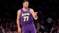 Los Angeles Lakers guard Luka Doncic (77) points in the direction of Knicks fan Spike Lee (not pictured) after a three point shot against the New York Knicks during the third quarter at Madison Square Garden.