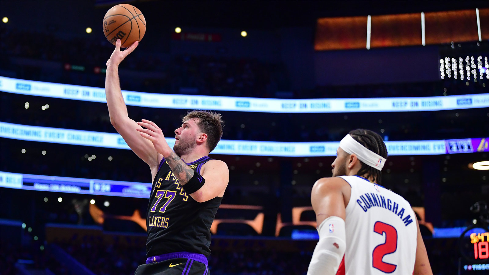 Los Angeles Lakers guard Luka Doncic (77) shoots against Detroit Pistons guard Cade Cunningham (2) during the second half at Crypto.com Arena. 