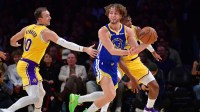 Golden State Warriors guard Brandin Podziemski (2) passes the ball against Los Angeles Lakers guard Luke Kennard (10) during the first half at Crypto.com Arena.