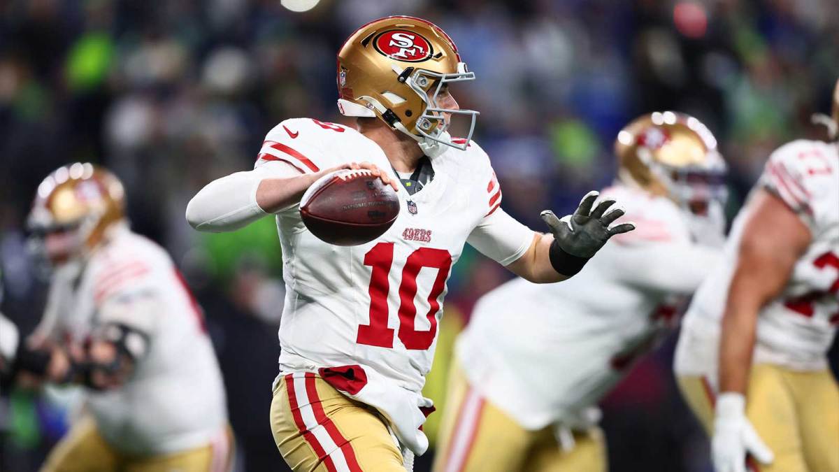 San Francisco 49ers quarterback Mac Jones (10) looks to throw downfield against the Seattle Seahawks during the second half in an NFC Divisional Round game at Lumen Field.
