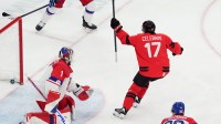 Macklin Celebrini of Canada celebrates after scoring their first goal in a men's ice hockey quarterfinal during the Milano Cortina 2026 Olympic Winter Games at Milano Santagiulia Ice Hockey Arena