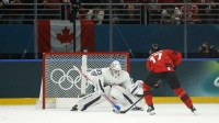 Macklin Celebrini of Canada scores their fifth goal against France in men's ice hockey group A play during the Milano Cortina 2026 Olympic Winter Games at Milano Santagiulia Ice Hockey Arena.