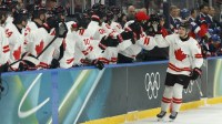 Macklin Celebrini of Canada celebrates scoring their first goal against Czechia in a men's ice hockey group A match during the Milano Cortina 2026 Olympic Winter Games at Milano Santagiulia Ice Hockey Arena.