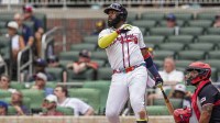 Atlanta Braves designated hitter Marcell Ozuna (20) hits a home run against the Washington Nationals during the eighth inning at Truist Park.