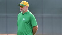 Athletics manager Mark Kotsay (7) looks on during a Spring Training workout at HoHhokum stadium.