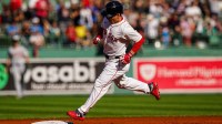Boston Red Sox designated hitter Masataka Yoshida (7) hits a home run against the Detroit Tigers in the first inning at Fenway Park.