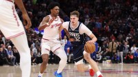Dallas Mavericks forward Cooper Flagg (32) drives with the ball as Houston Rockets guard Amen Thompson (1) defends during the fourth quarter at Toyota Center.