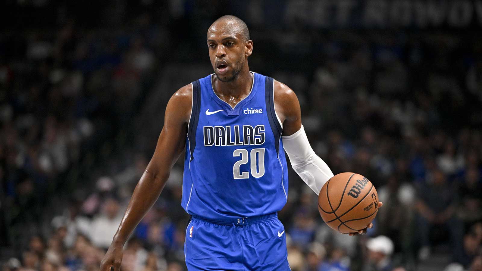 Dallas Mavericks forward Khris Middleton (20) brings the ball up court against the Sacramento Kings during the first quarter at the American Airlines Center.