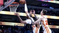 Dallas Mavericks center Daniel Gafford (21) shoots past Atlanta Hawks forward Onyeka Okongwu (17) and Atlanta Hawks guard Vit Krejci (27) during the first half at American Airlines Center