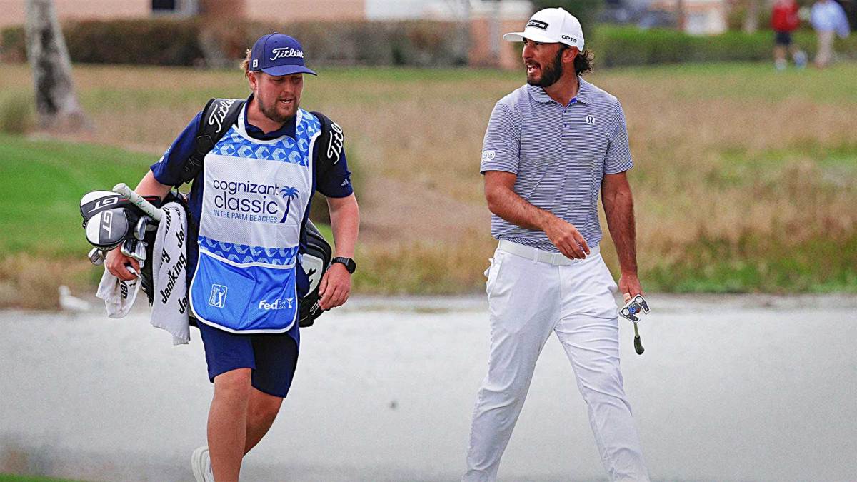Max Homa (right) walks up to the eighth green with his caddie during the first round of the Cognizant Classic golf tournament.