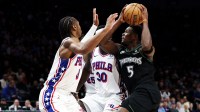 Minnesota Timberwolves guard Anthony Edwards (5) drives towards the basket as Philadelphia 76ers guard Tyrese Maxey (0) defends during the second half at Target Center.