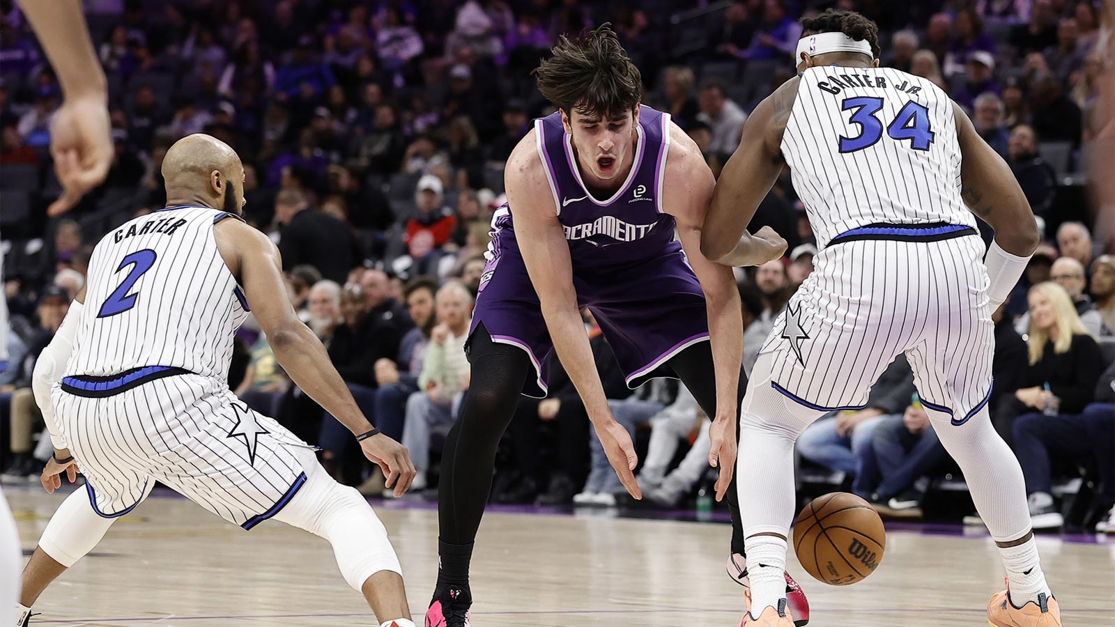 Sacramento Kings center Maxime Raynaud (42) loses the ball between Orlando Magic guard Jevon Carter (2) and forward Wendell Carter Jr. (34) during the fourth quarter at Golden 1 Center. 