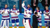 Connor Hellebuyck of the United States celebrates after winning the men's ice hockey gold medal game during the Milano Cortina 2026 Olympic Winter Games at Milano Santagiulia Ice Hockey Arena.