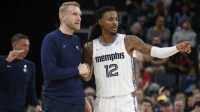 Memphis Grizzlies head coach Tuomas Iisalo talks with guard Ja Morant (12) during the fourth quarter against the Milwaukee Bucks at FedExForum.