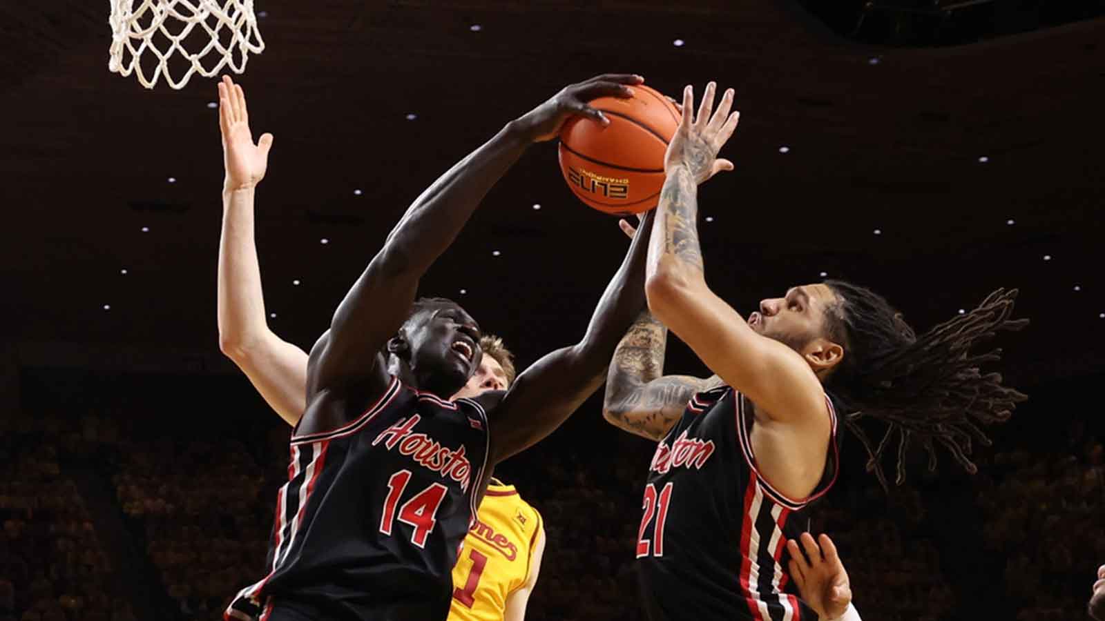Houston Cougars forward Kalifa Sakho (14) and Houston Cougars guard Emanuel Sharp (21) battle for a rebound against the Iowa State Cyclones during the first half at James H. Hilton Coliseum.