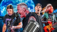 James Hetfield singing in the middle, Lars Ulrich, Kirk Hammett, and Robert Trujilo with Las Vegas Sphere background.