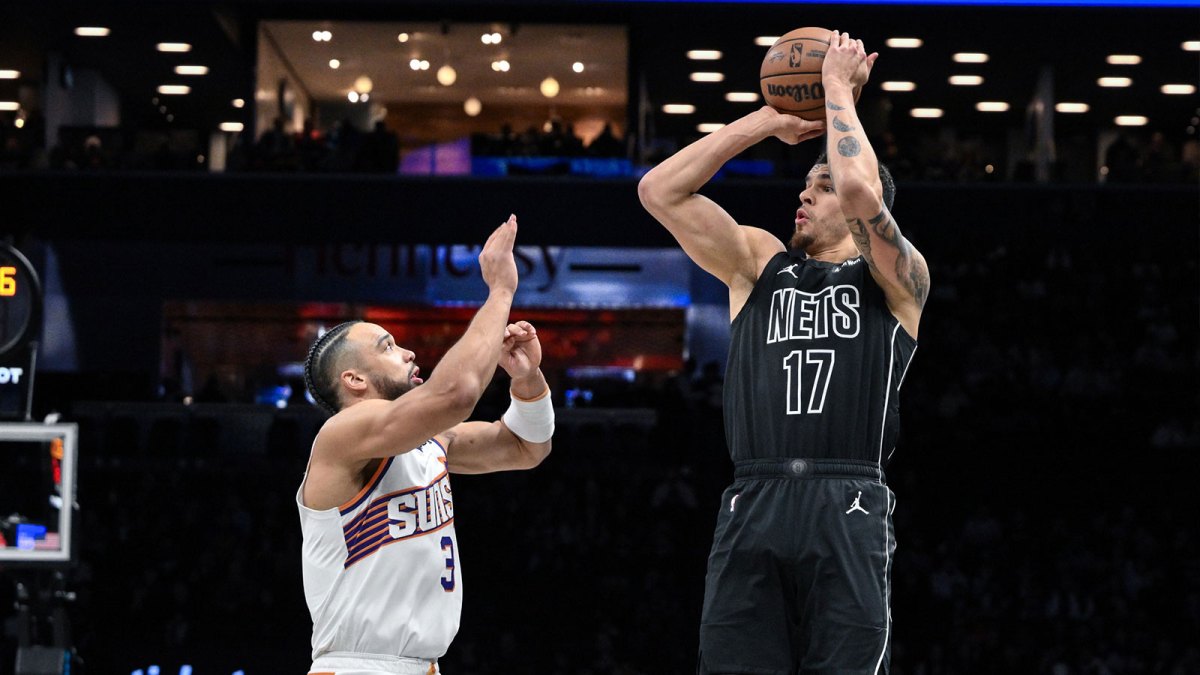 Brooklyn Nets forward Michael Porter Jr. (17) shoots the ball against Phoenix Suns guard/forward Dillon Brooks (3) during the first half at Barclays Center.