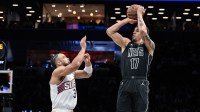 Brooklyn Nets forward Michael Porter Jr. (17) shoots the ball against Phoenix Suns guard/forward Dillon Brooks (3) during the first half at Barclays Center.