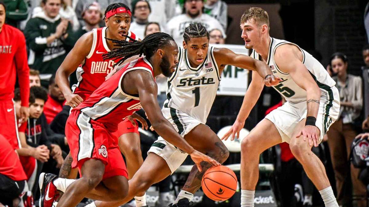 Michigan State's Jeremy Fears Jr., center, defends against Ohio State's Bruce Thornton, left, during the second half on Sunday, Feb. 22, 2026, at the Breslin Center in East Lansing.