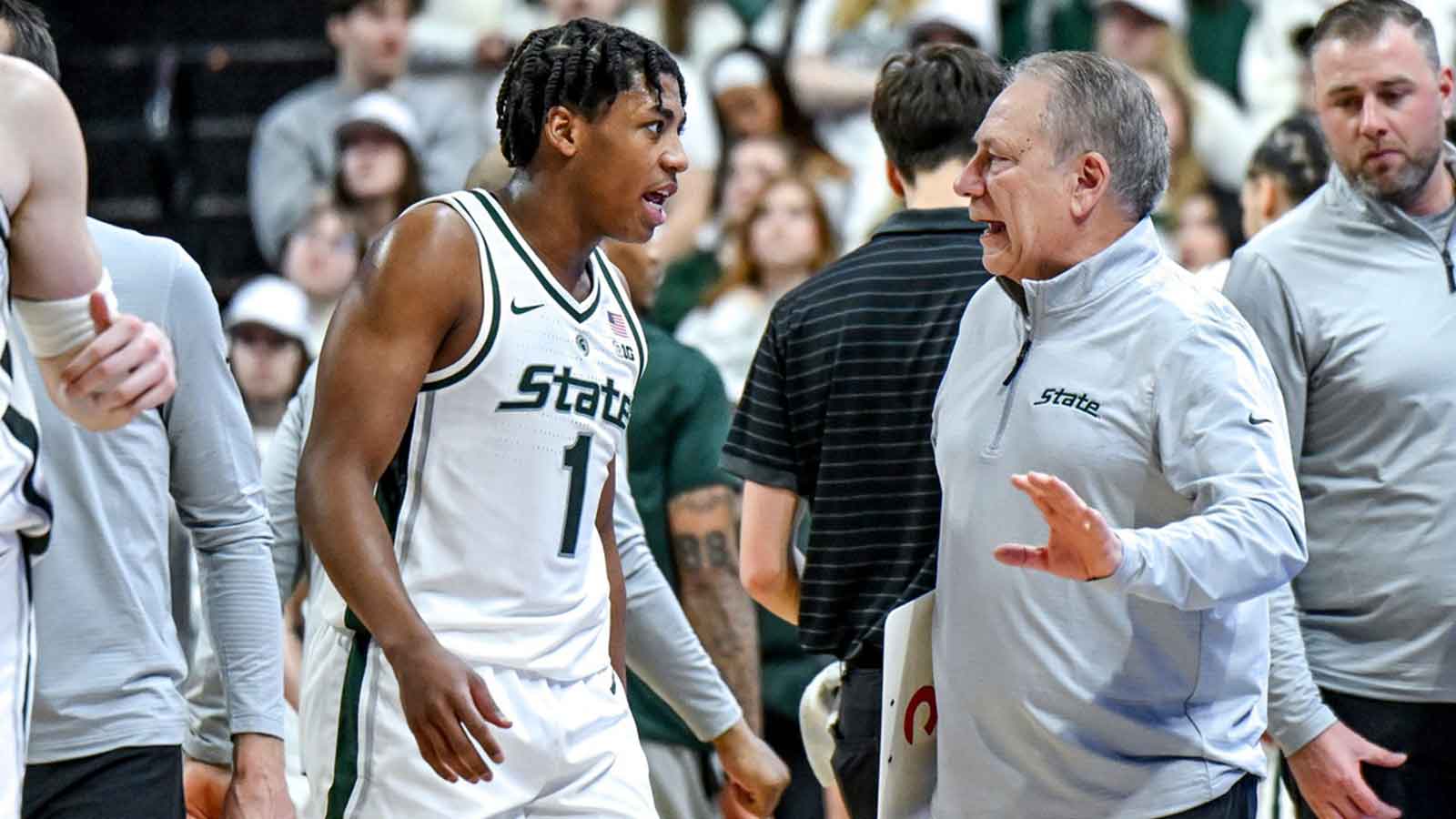 Michigan State's head coach Tom Izzo, right, talks with Jeremy Fears Jr. during the first half in the game against Maryland