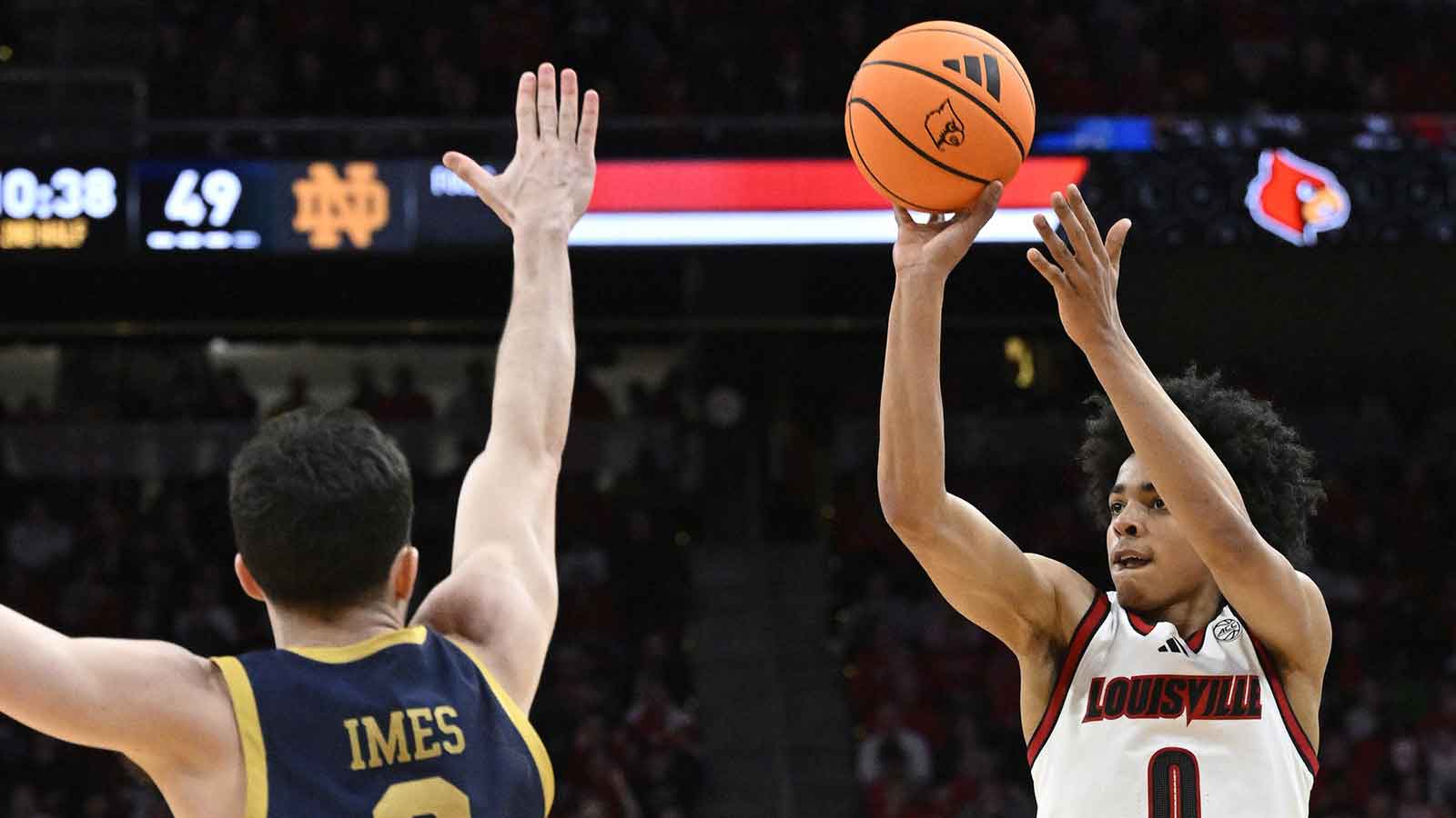 Louisville Cardinals guard Mikel Brown Jr. (0) shoots against Notre Dame Fighting Irish guard Logan Imes (2) during the second half at KFC Yum! Center. Louisville defeated Notre Dame 76-65.