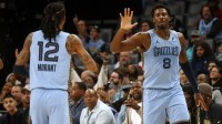Memphis Grizzlies forward/center Jaren Jackson Jr. (8) reacts with guard Ja Morant (12) during the first quarter against the Atlanta Hawks at FedExForum.