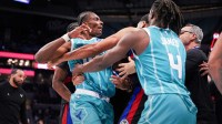 Charlotte Hornets forward Moussa Diabaté (14) is held back by guard Sion James (4) engaging with Detroit Pistons forward Tobias Harris (12) during the second half at Spectrum Center. Mandatory Credit: Jim Dedmon-Imagn Images