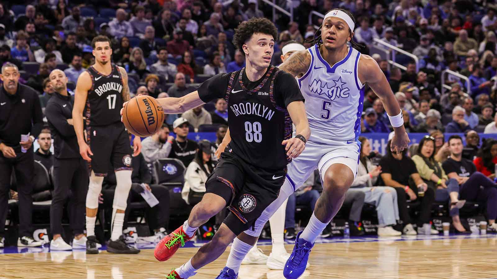 Brooklyn Nets guard Nolan Traore (88) drives around Orlando Magic forward Paolo Banchero (5) during the second quarter at Kia Center.