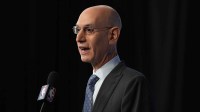 NBA commissioner Adam Silver speaks to the media during a press conference before 2026 NBA All Star Saturday Night at Intuit Dome with the Pacers and Jazz logos in the background