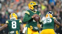 Green Bay Packers quarterback Malik Willis, center, drops back to pass during the second quarter against the Baltimore Ravens at Lambeau Field.