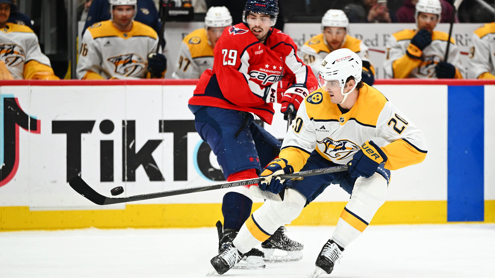 Nashville Predators defenseman Justin Barron (20) and Washington Capitals center Hendrix Lapierre (29) battle for the puck during the second period at Capital One Arena.