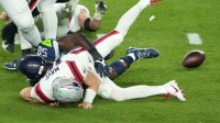 New England Patriots quarterback Drake Maye (10) fumbles as he is sacked by Seattle Seahawks linebacker Derick Hall (58) in the second half in Super Bowl LX at Levi's Stadium.