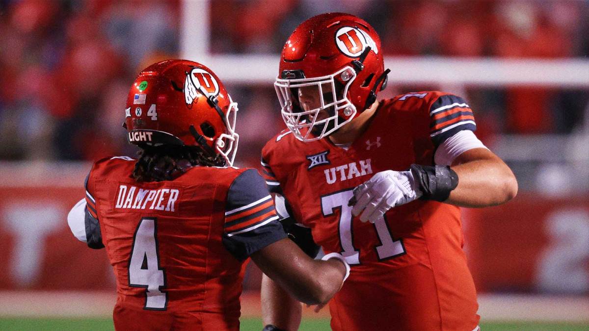Utah Utes quarterback Devon Dampier (4) celebrates scoring a touchdown against the Arizona State Sun Devils with Utah Utes offensive lineman Caleb Lomu (71) during the second quarter at Rice-Eccles Stadium.
