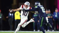 New England Patriots quarterback Drake Maye (10) runs against Seattle Seahawks linebacker Ernest Jones IV (13) during the third quarter in Super Bowl LX at Levi's Stadium.