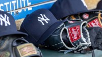 New York Yankees baseball hats and gloves in the dugout out in the eighth inning against the Detroit Tigers at Comerica Park.