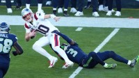 New England Patriots quarterback Drake Maye (10) runs against Seattle Seahawks safety Nick Emmanwori (3) during the first quarter in Super Bowl LX at Levi's Stadium.