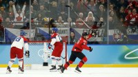 Nick Suzuki of Canada celebrates after scoring their third goal against Czechia in a men's ice hockey quarterfinal during the Milano Cortina 2026 Olympic Winter Games at Milano Santagiulia Ice Hockey Arena.