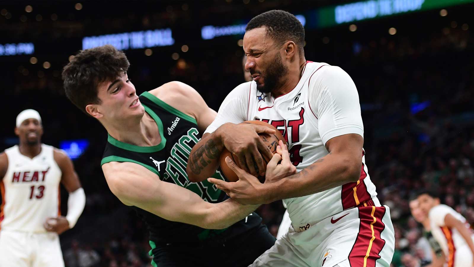 Boston Celtics guard Hugo Gonzalez (28) and Miami Heat guard Norman Powell (24) battle for the ball during the second half at TD Garden.