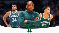 Bucks forward Ousmane Dieng next to Bucks coach Doc Rivers & Bucks All-Star Giannis Antetokounmpo with the Bucks logo in the background