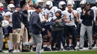 Oxford native and Yale head coach Tony Reno celebrates a field goal that gives the Bulldogs a 17-14 lead over Holy Cross in the second quarter on Saturday.