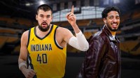 Ivica Zubac in Pacers uniform, with Tyrese Haliburton beside him in casual clothes