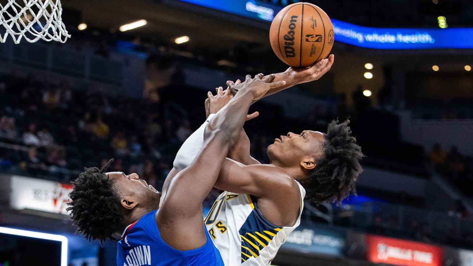 Pacers guard Bennedict Mathurin (00) shoots the ball while LA Clippers guard Kobe Brown (21) defends in the second half at Gainbridge Fieldhouse