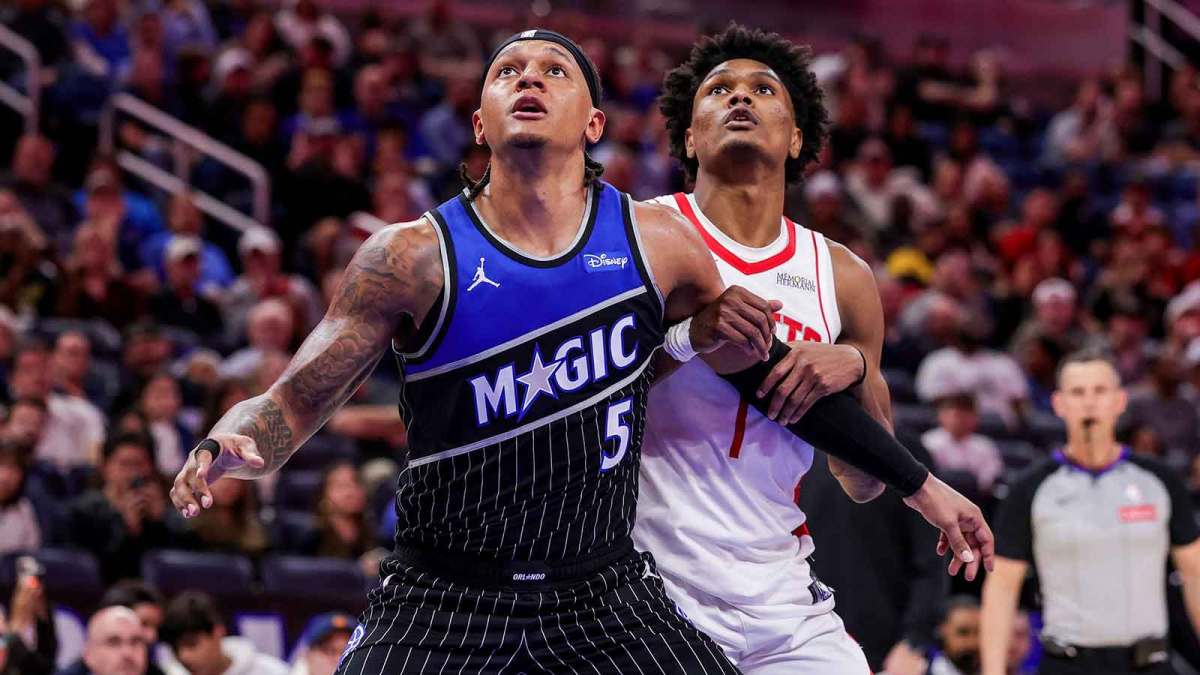 Orlando Magic forward Paolo Banchero (5) and Houston Rockets guard Amen Thompson (1) watch for the rebound during the second half at Kia Center.