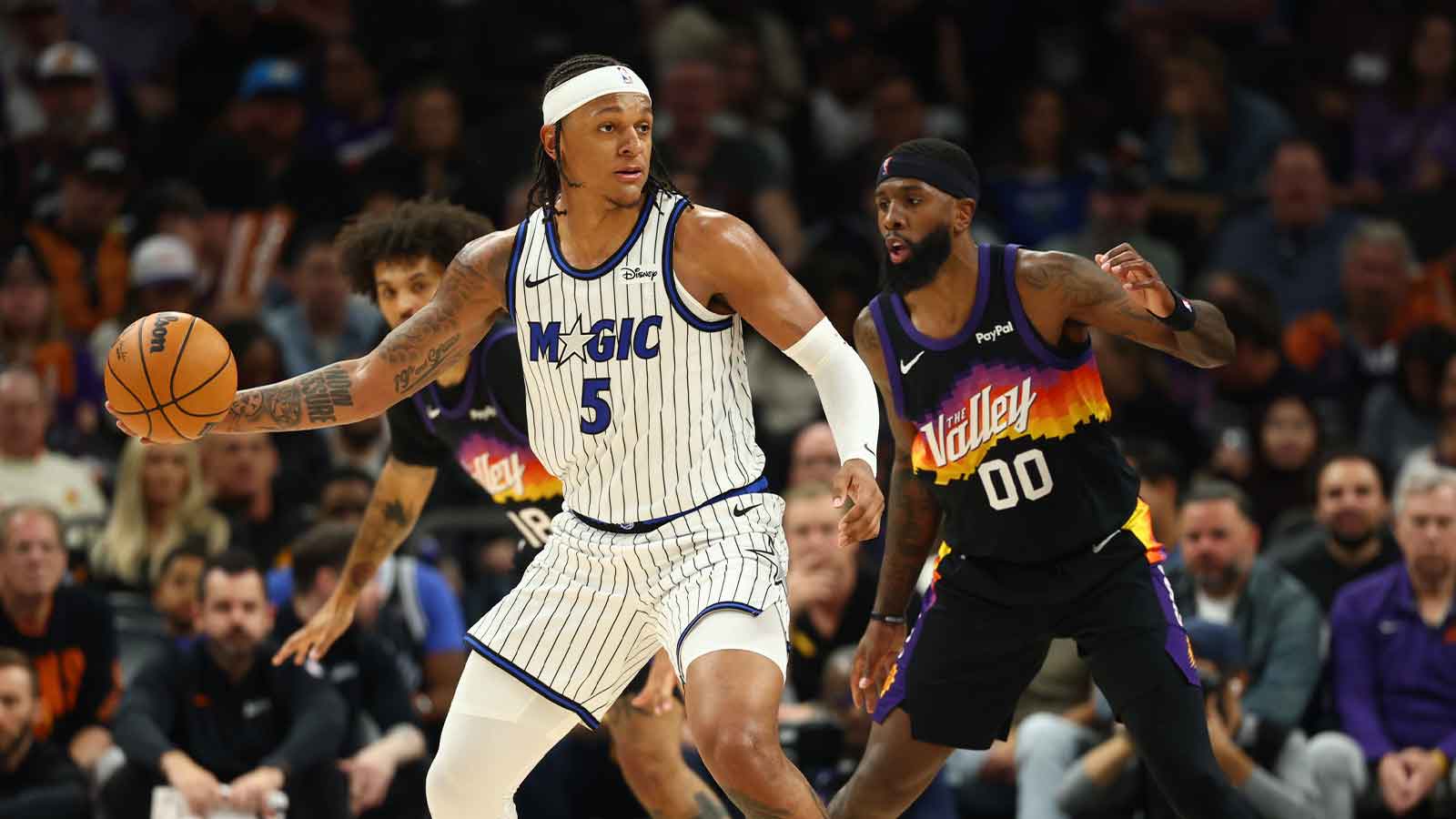 Orlando Magic forward Paolo Banchero (5) controls the ball against Phoenix Suns forward Royce O'Neale (00) n the first half at Mortgage Matchup Center.