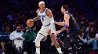Orlando Magic forward Paolo Banchero (5) moves the ball against Los Angeles Lakers guard Luka Doncic (77) during the second half at Crypto.com Arena.